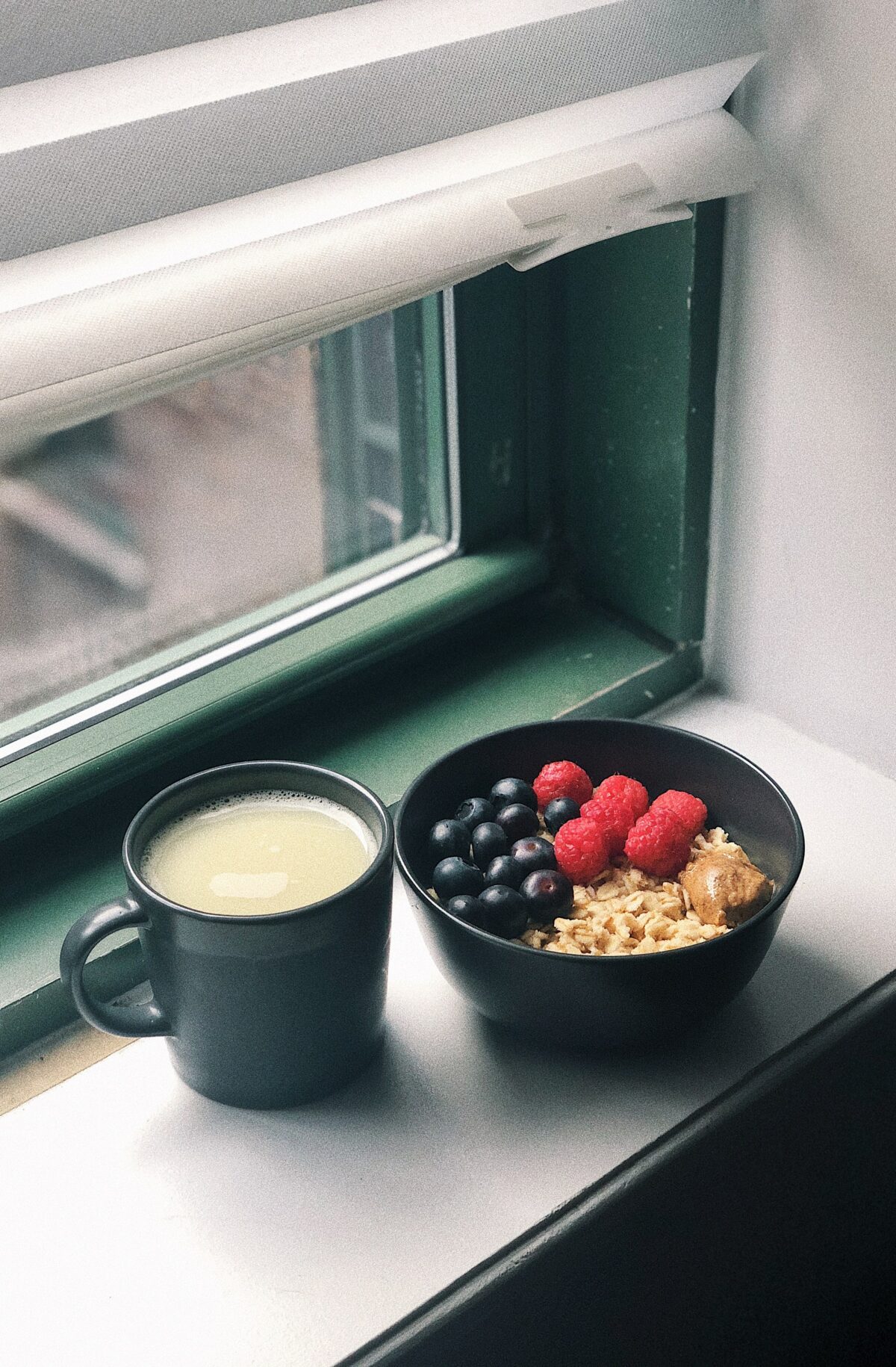 black ceramic mug with white liquid inside