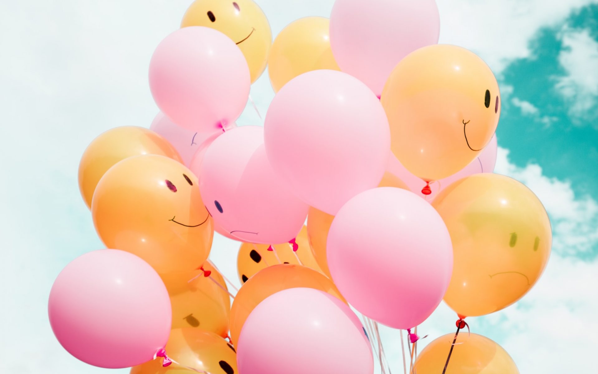 low-angle photo of pink and orange balloons